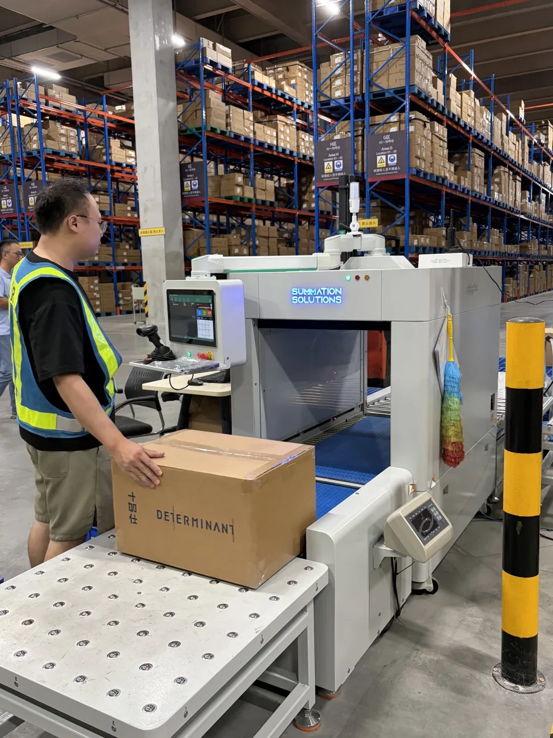 A carton being processed on a roller conveyor at a warehouse station